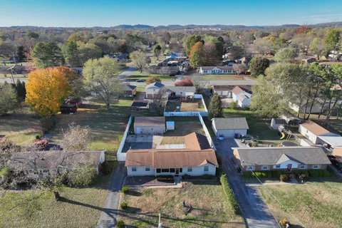 a view of a house with a backyard