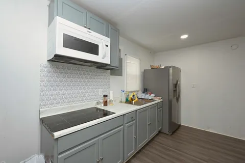 a living room with a couch and a refrigerator