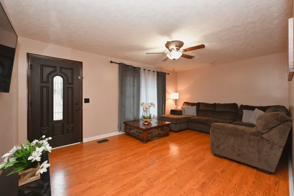 a living room with furniture flowerpot and a chandelier