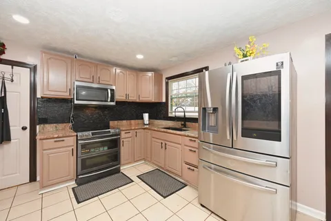 a kitchen with cabinets and appliances