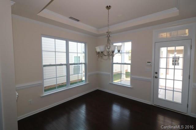 5165 Waterloo Drive, Unit CC153 Tega Cay, SC 29708 - Photo 4 of 6 a view of an empty room with wooden floor and a window