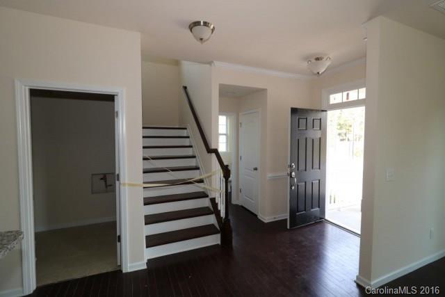 5165 Waterloo Drive, Unit CC153 Tega Cay, SC 29708 - Photo 5 of 6 a view of a hallway with wooden floor and stairs