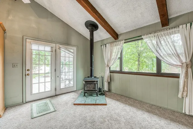 a spacious bathroom with a granite countertop sink a toilet and a large mirror