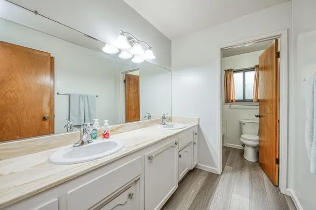 a view of a livingroom with wooden floor and stairs