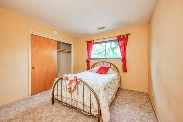 a bedroom with a bed and a window