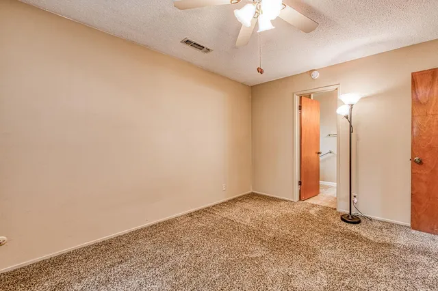 a view of a patio with two chairs and a table under an umbrella