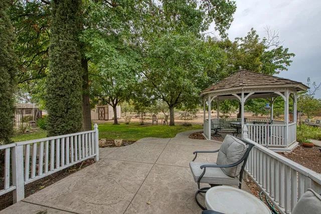 a view of a chairs and table in the balcony