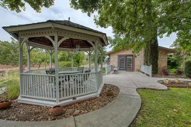 a view of a house with a yard and tree s