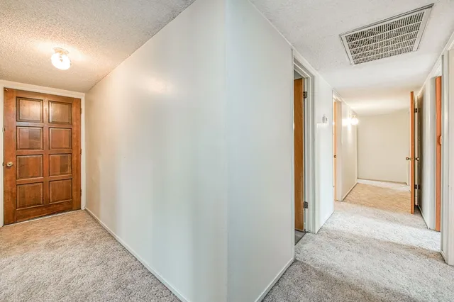 a view of hallway with wooden floor