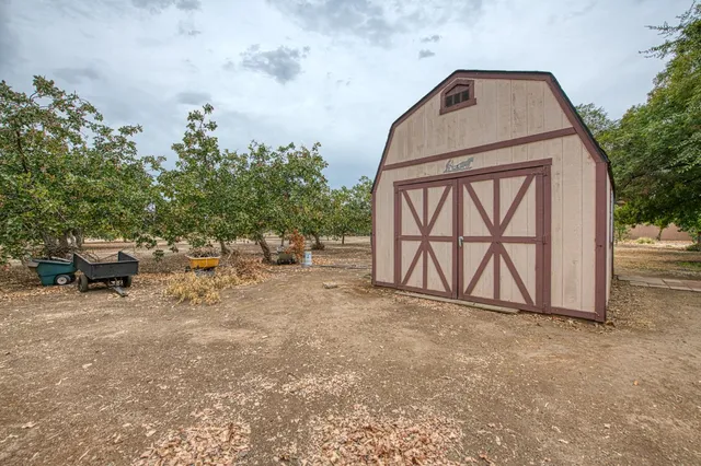 a view of house with swimming pool and outdoor seating
