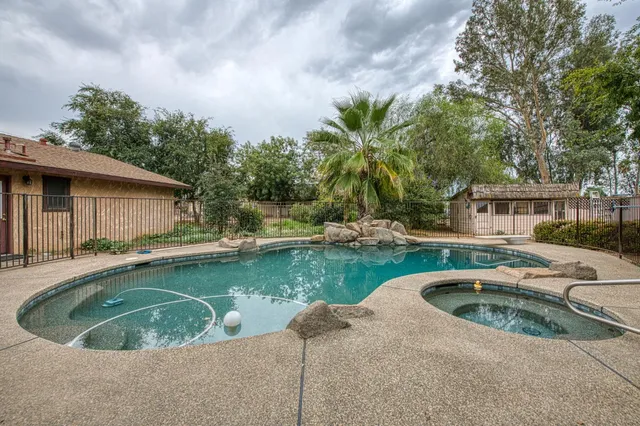 a view of a house with pool and chairs