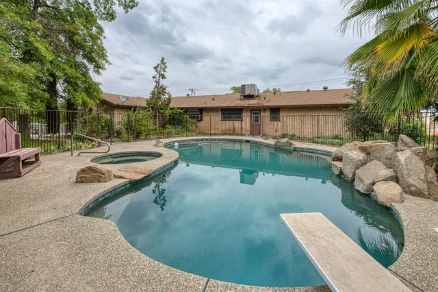 an aerial view of a house with a yard basket ball court