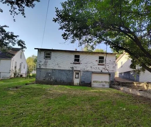 a front view of house with yard and trees