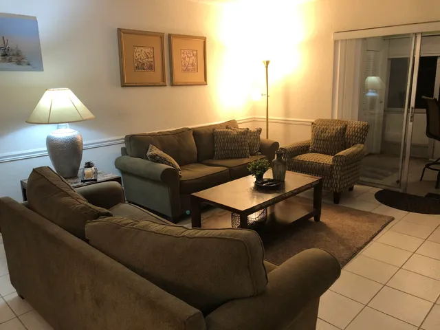 a living room with furniture and a lamp