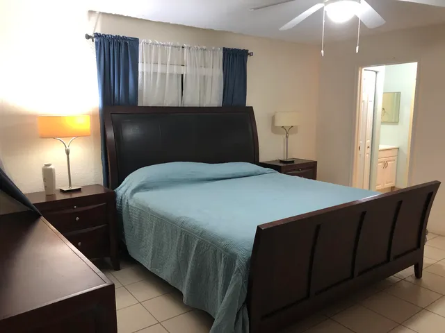 a bedroom with a bed and a lamp