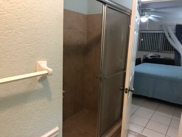 a bathroom with a shower and a sink