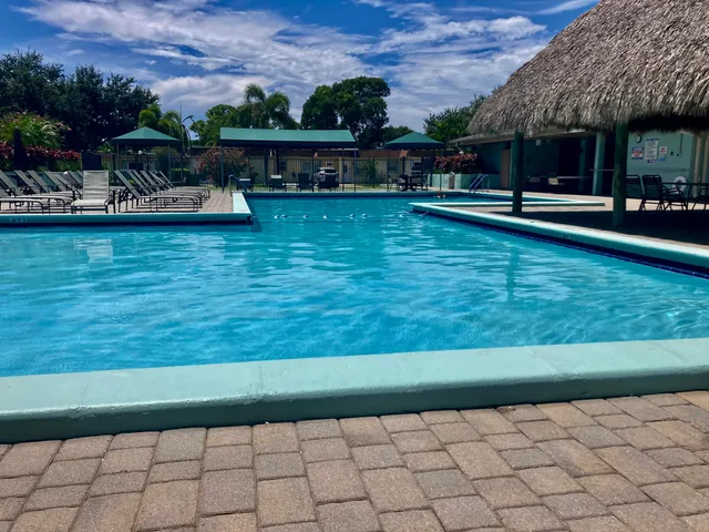 a view of a swimming pool with lawn chairs