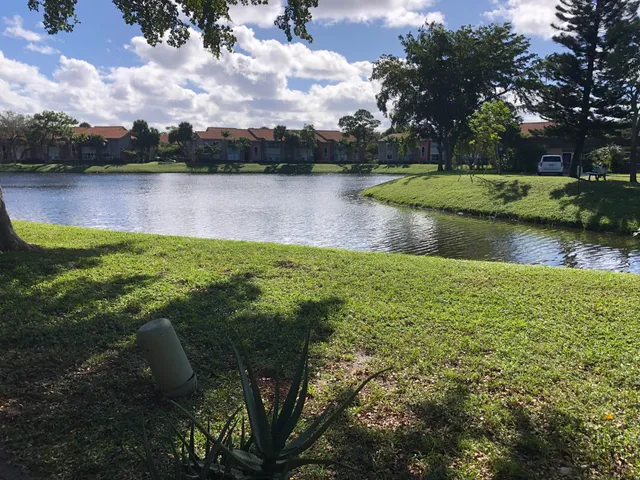 a view of a lake with houses in the back