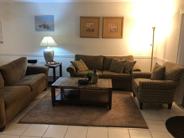 a living room with furniture and a lamp