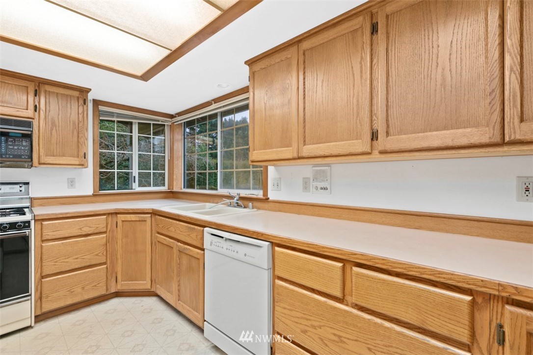 242 Middlefield Road Bellingham, WA 98225 - Photo 14 of 31 a kitchen with a sink and cabinets