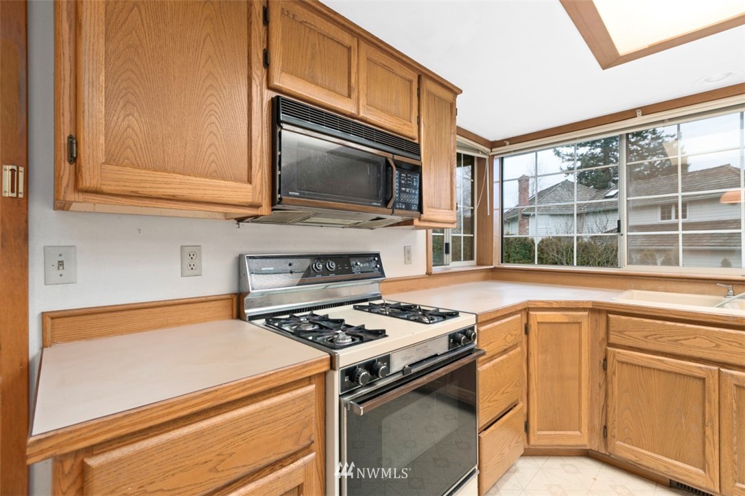 242 Middlefield Road Bellingham, WA 98225 - Photo 15 of 31 a kitchen with white cabinets and a stove top oven