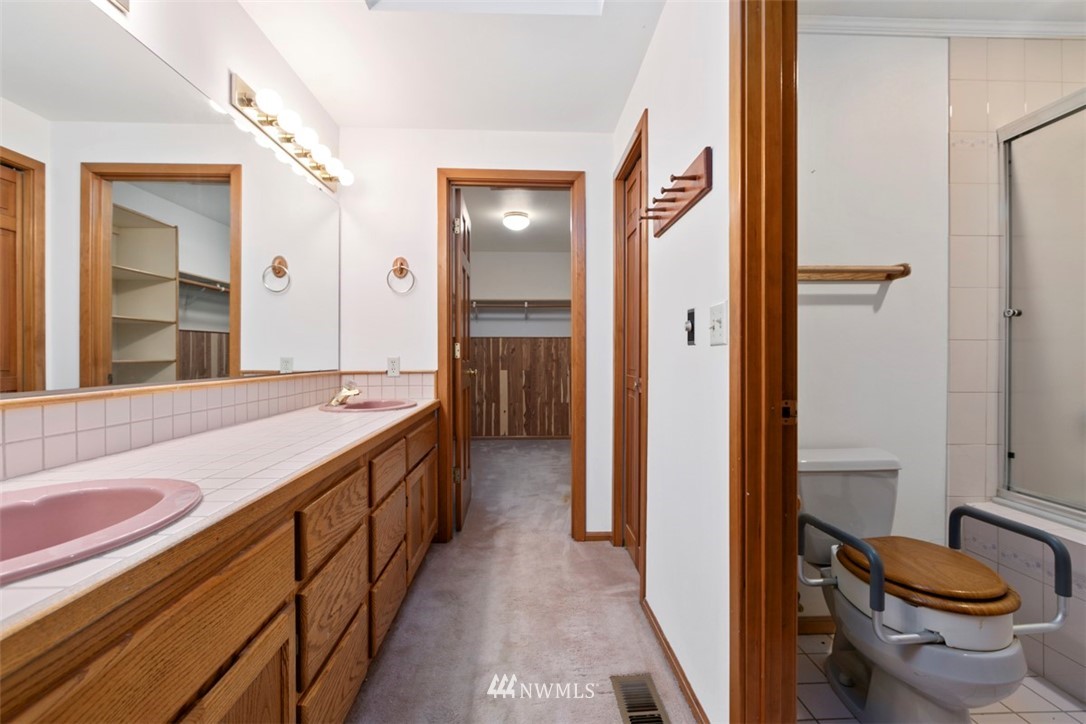 242 Middlefield Road Bellingham, WA 98225 - Photo 23 of 31 a spacious bathroom with a granite countertop sink and a mirror