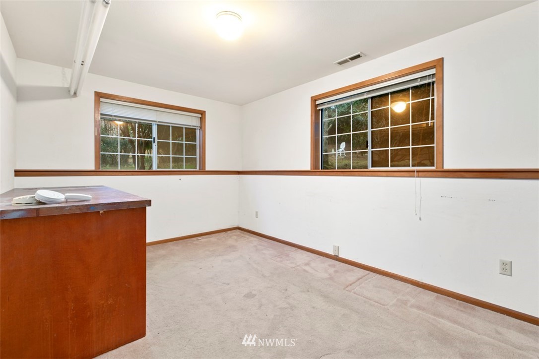 242 Middlefield Road Bellingham, WA 98225 - Photo 25 of 31 an empty room with wooden floor and windows