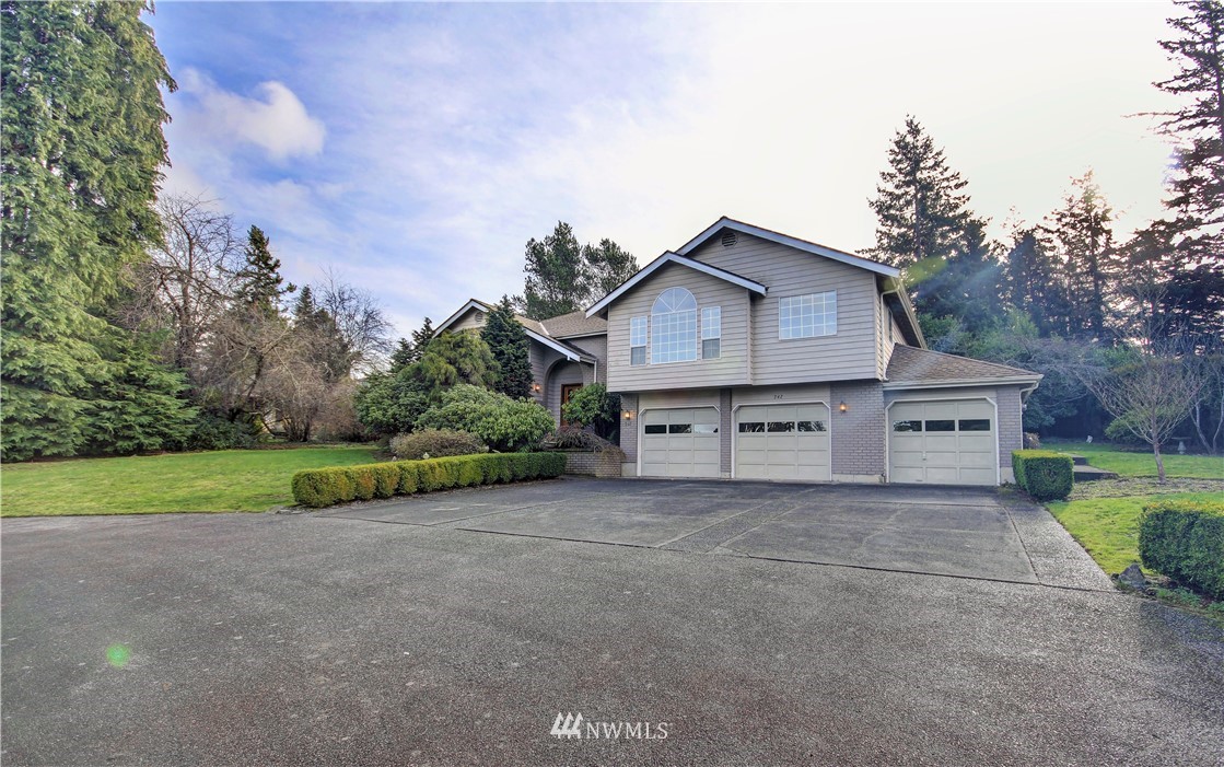 242 Middlefield Road Bellingham, WA 98225 - Photo 30 of 31 a view of a house with a big yard and large trees