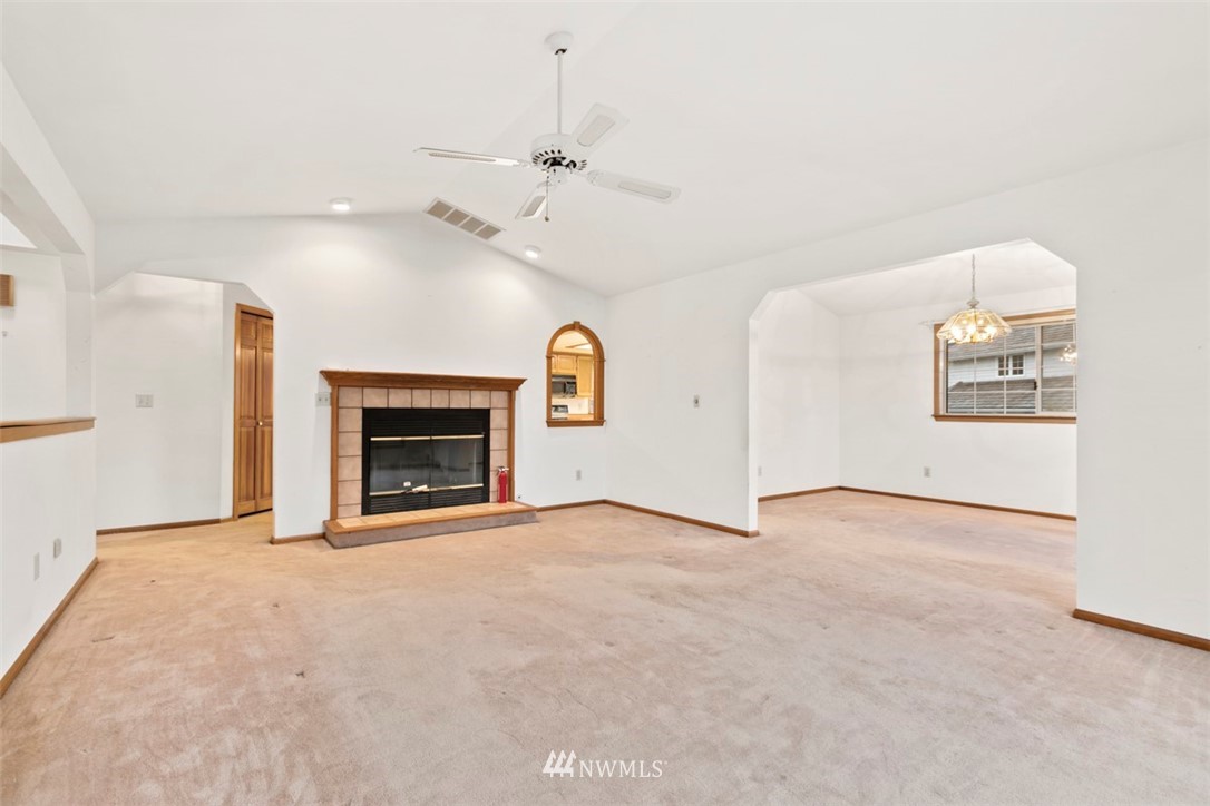 242 Middlefield Road Bellingham, WA 98225 - Photo 7 of 31 an empty room with windows and fireplace