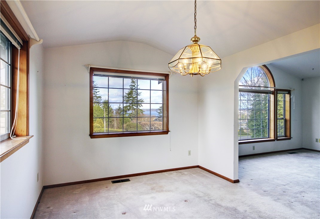 242 Middlefield Road Bellingham, WA 98225 - Photo 8 of 31 an empty room with windows and chandelier