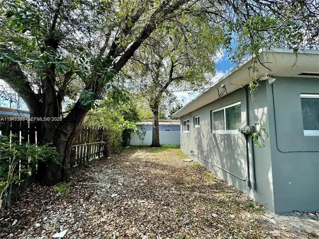 a bathroom with a granite countertop shower and a mirror