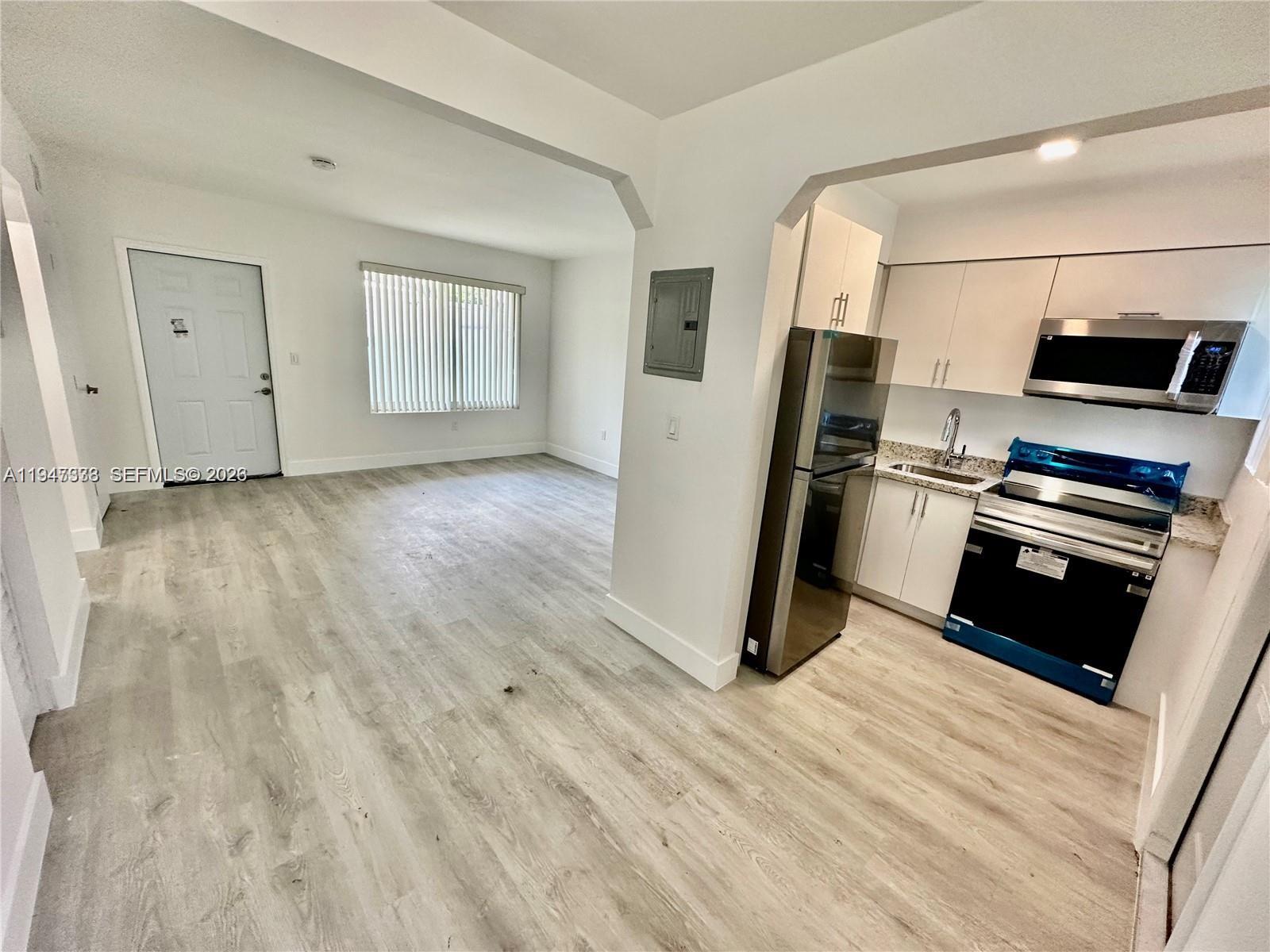 1894 Northwest 53rd Street Miami, FL 33142 - Photo 7 of 19 a view of kitchen and wooden floor