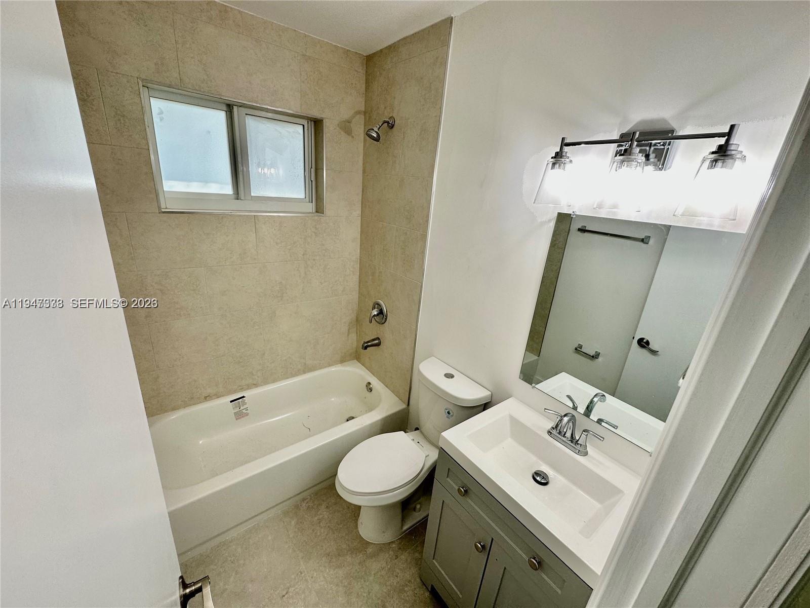 1894 Northwest 53rd Street Miami, FL 33142 - Photo 9 of 19 a bathroom with a sink toilet tub and shower
