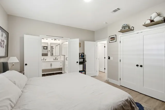 a bedroom with a bed and a refrigerator