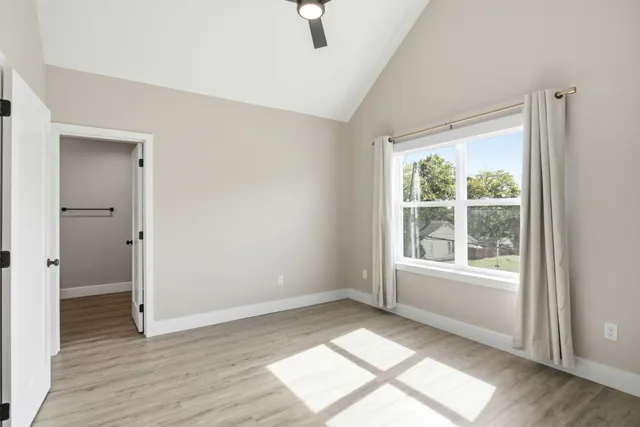 a view of an empty room with wooden floor
