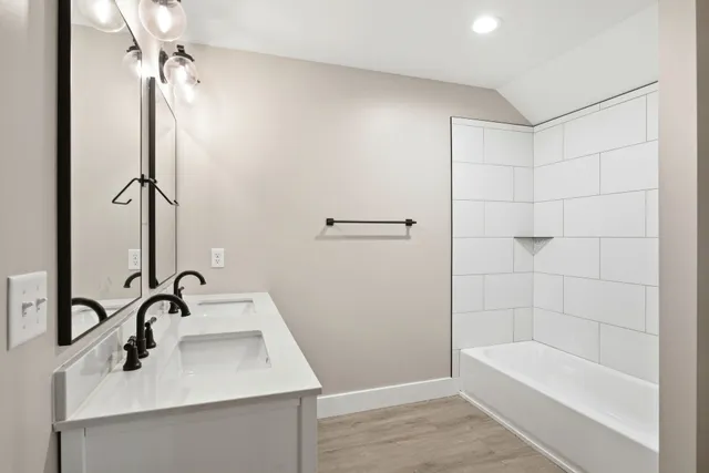 a bathroom with a bathtub and shower