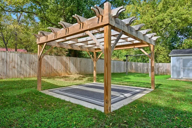 a view of a yard with wooden fence