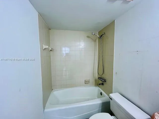 a bathroom with a bathtub and shower