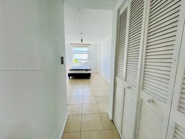 a view of a room that has a bed and a window in it