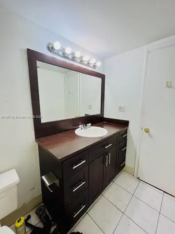 a bathroom with a sink vanity and a mirror