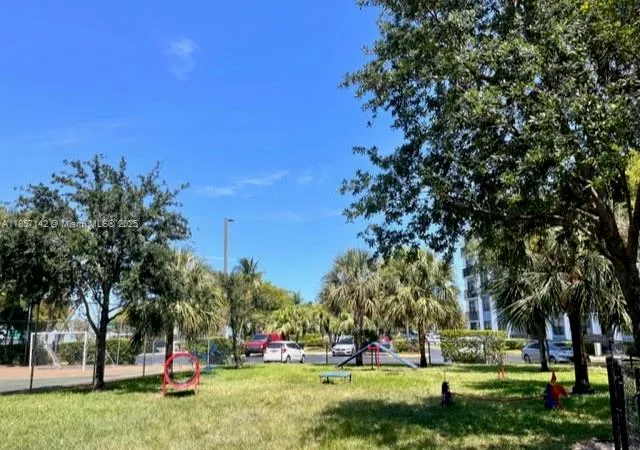 a view of a playground with basketball court