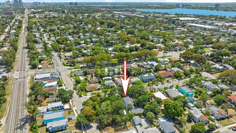 an aerial view of residential houses with outdoor space and trees