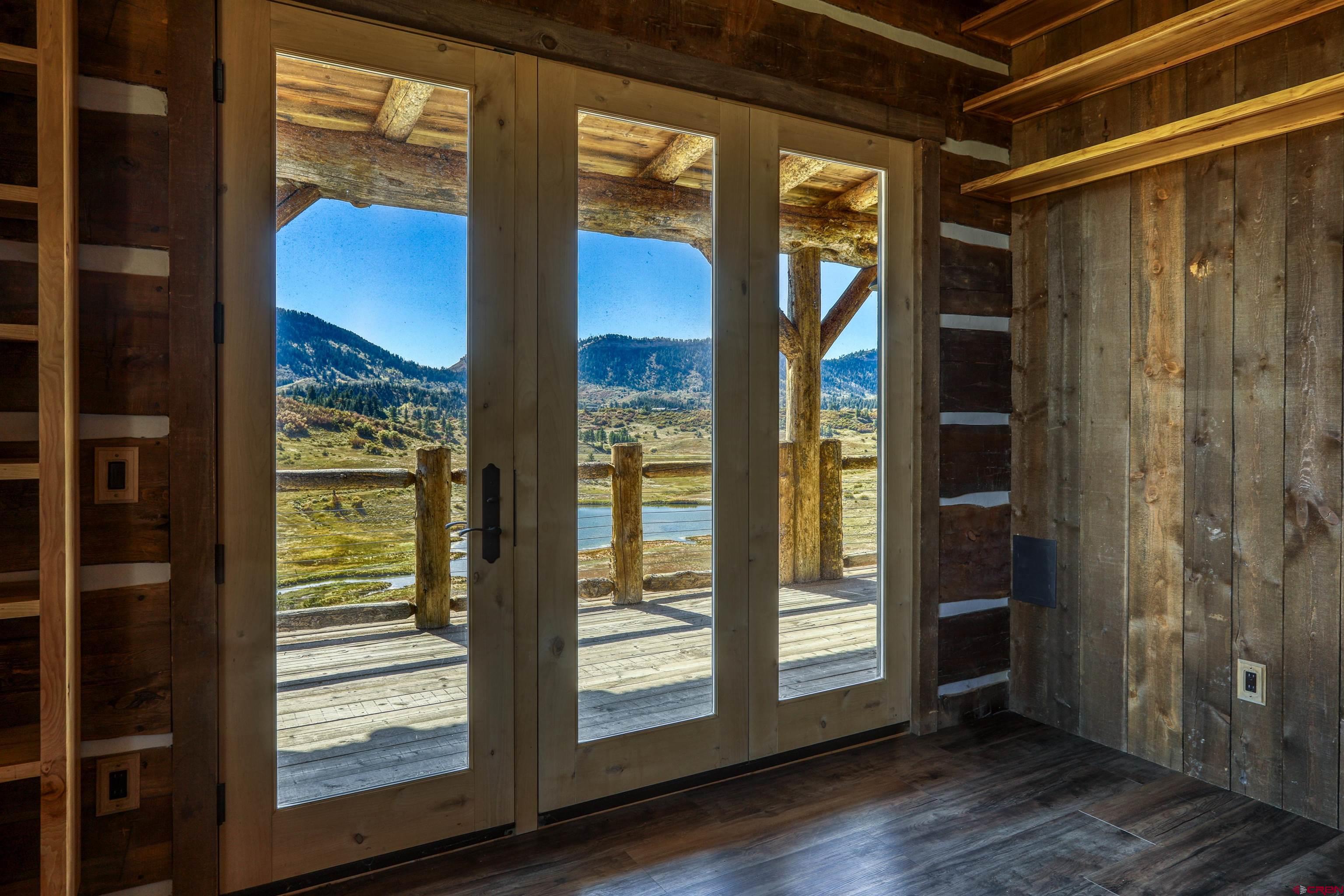 521 Spring Creek Circle Chromo, CO 81128 - Photo 11 of 35 a view of an entryway with wooden floor and door
