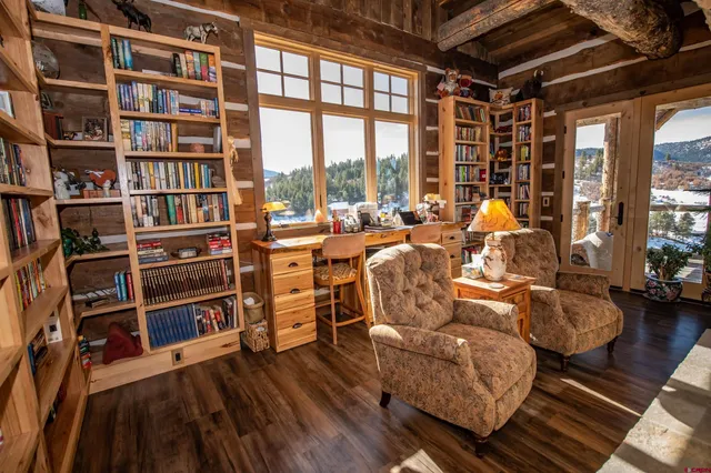 a view of room with wooden floor and windows