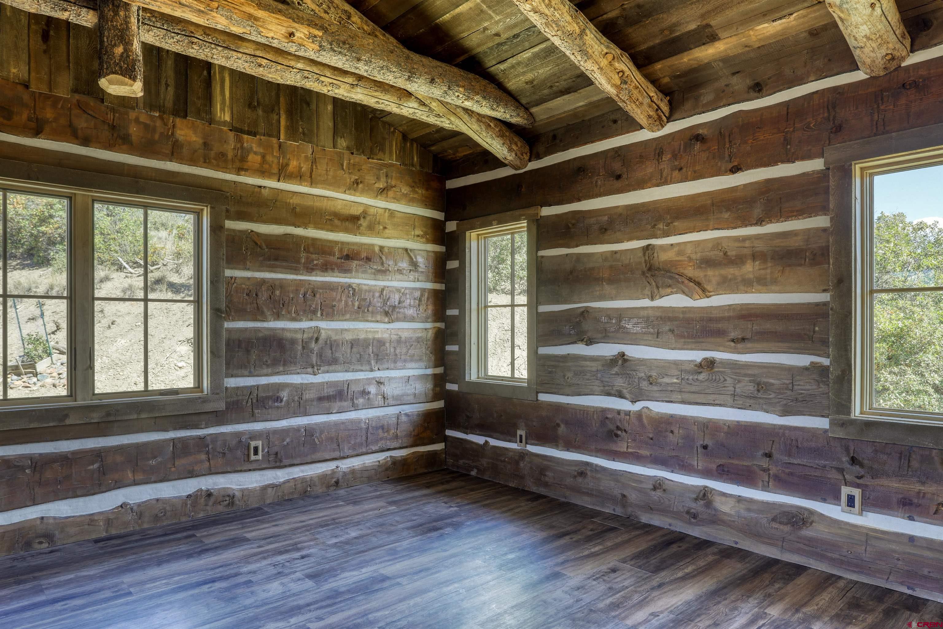 521 Spring Creek Circle Chromo, CO 81128 - Photo 15 of 35 a view of room with wooden floor and windows