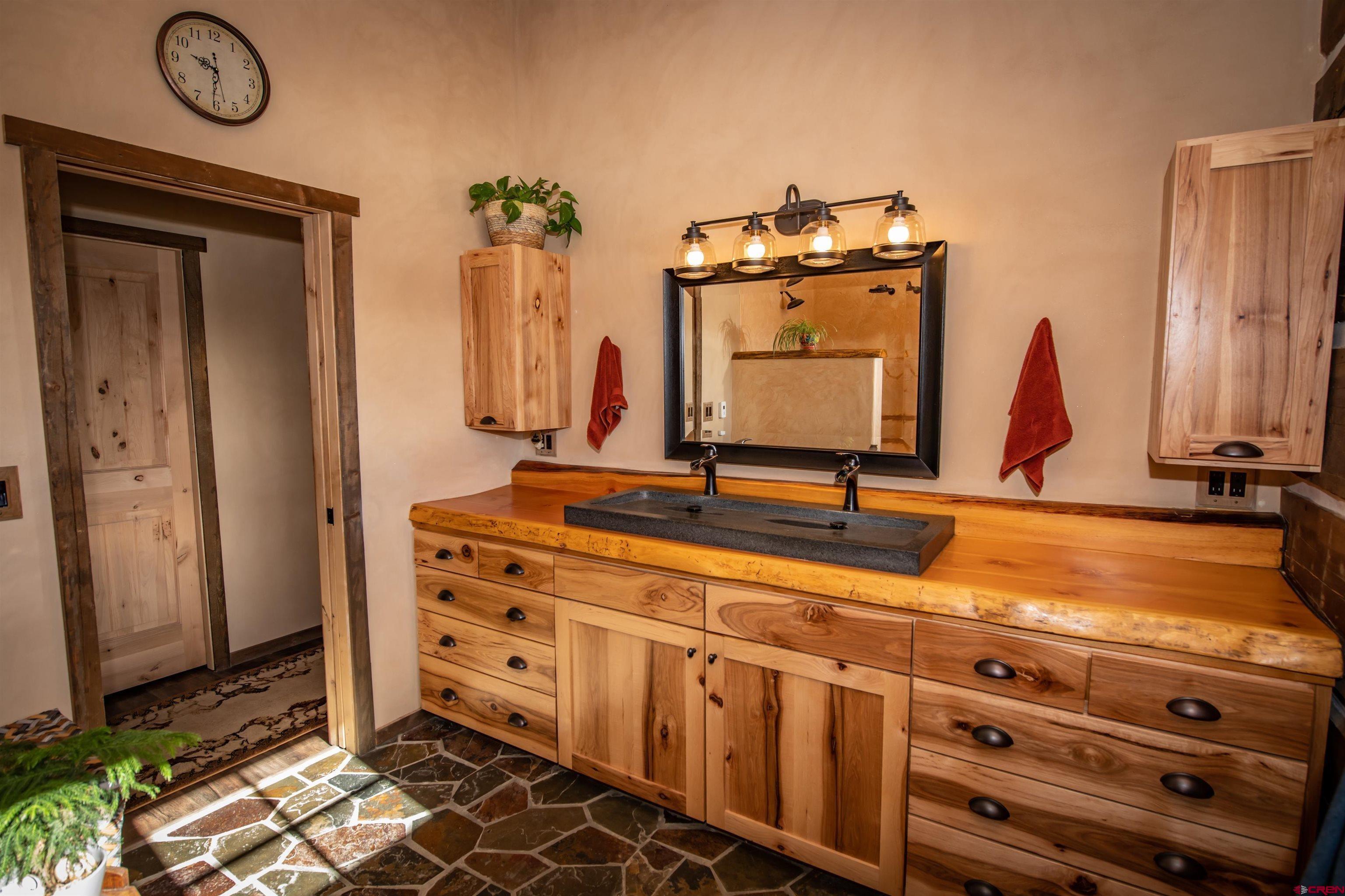 521 Spring Creek Circle Chromo, CO 81128 - Photo 20 of 35 a bathroom with a double vanity sink and a mirror