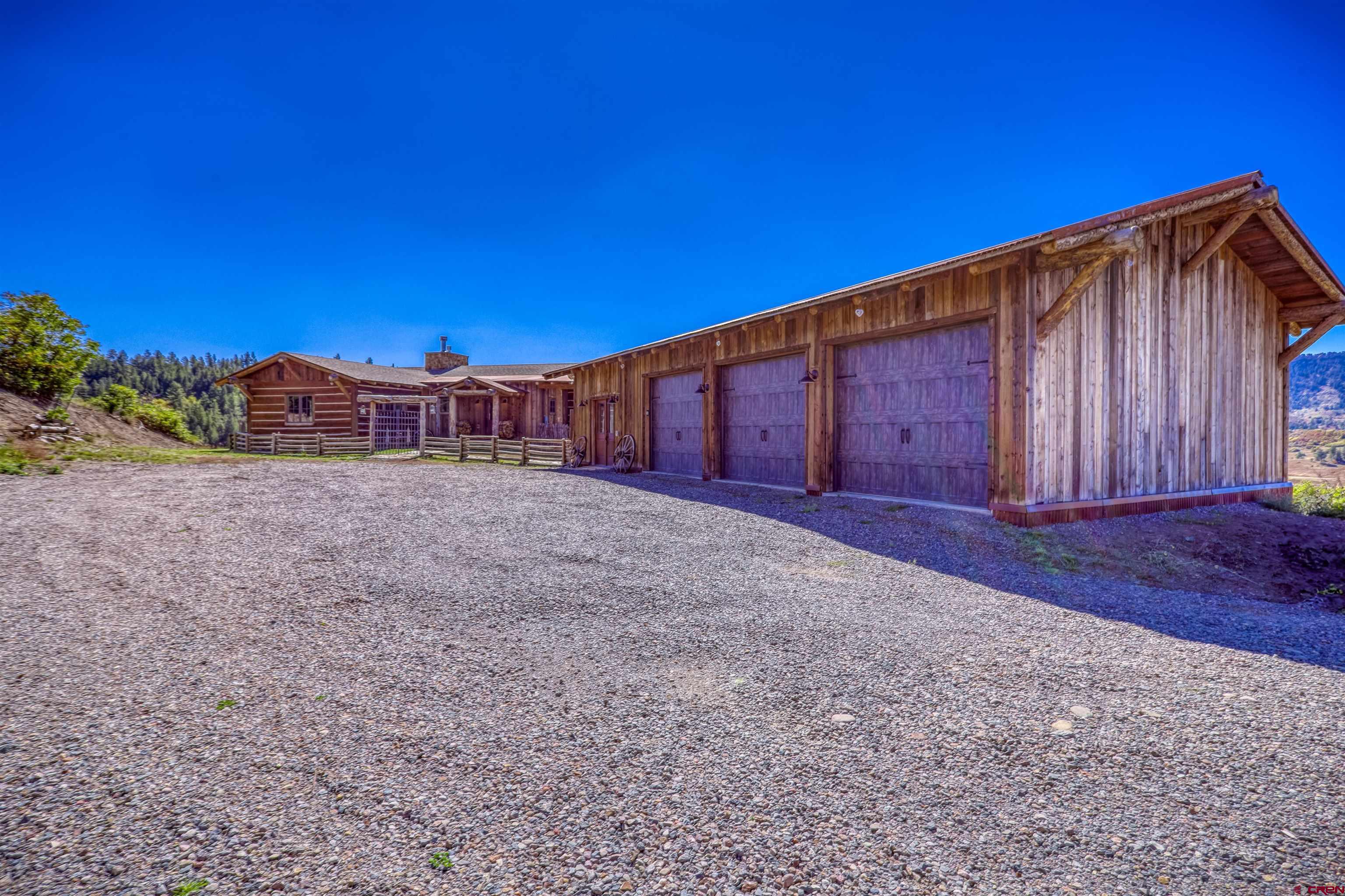 521 Spring Creek Circle Chromo, CO 81128 - Photo 27 of 35 a view of a backyard with wooden fence