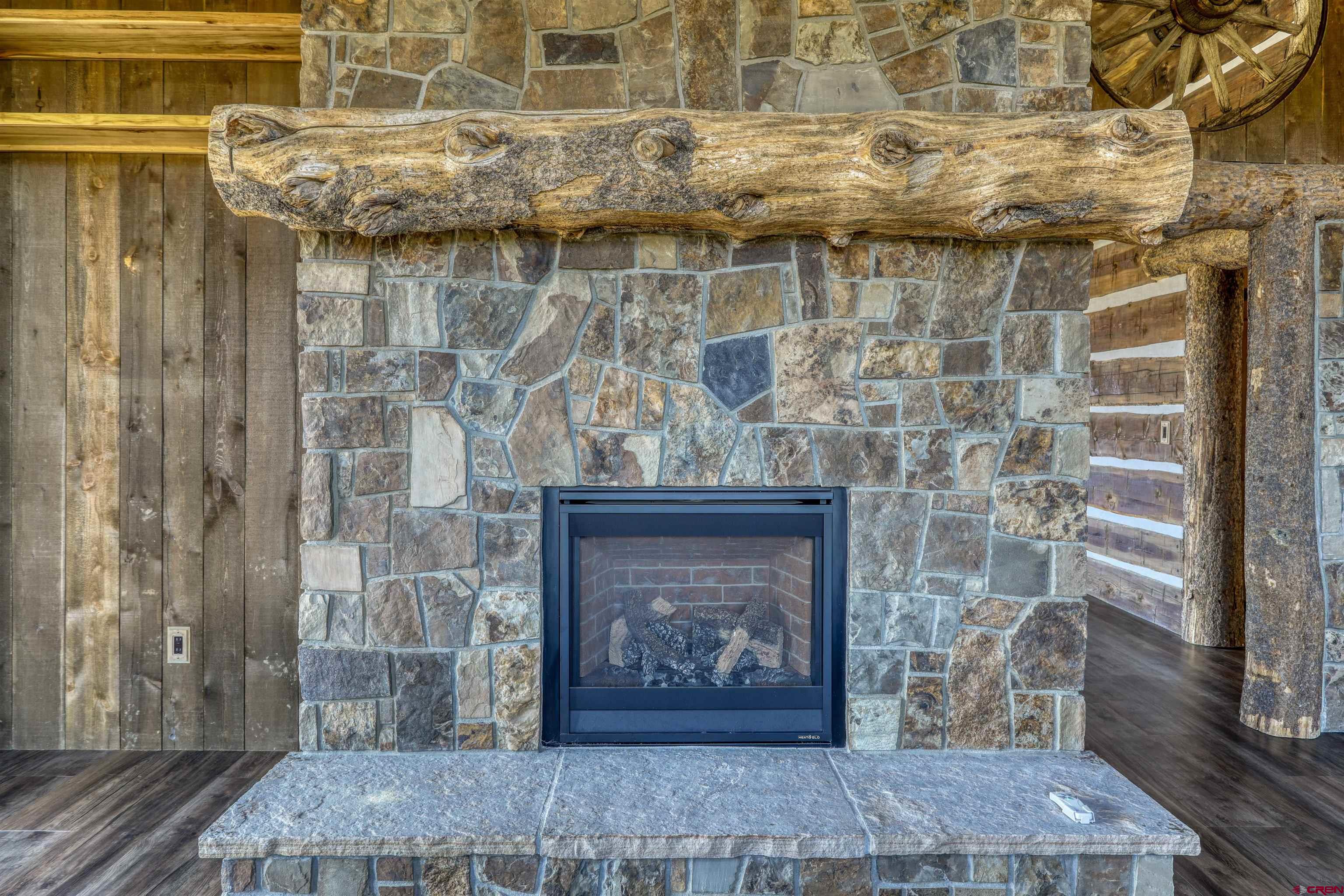 521 Spring Creek Circle Chromo, CO 81128 - Photo 5 of 35 a room with a fireplace and a wooden door