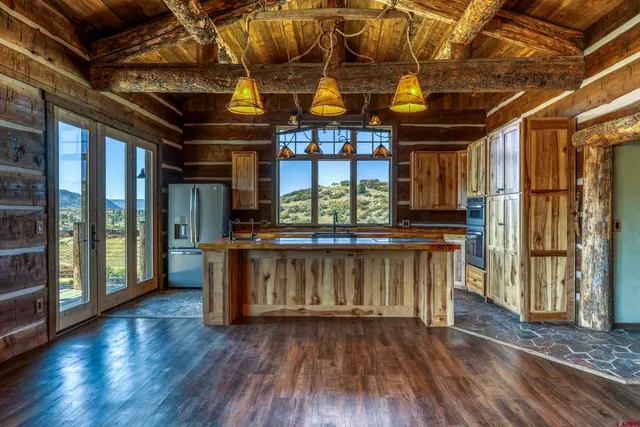 a kitchen with stainless steel appliances granite countertop a sink and wooden cabinets