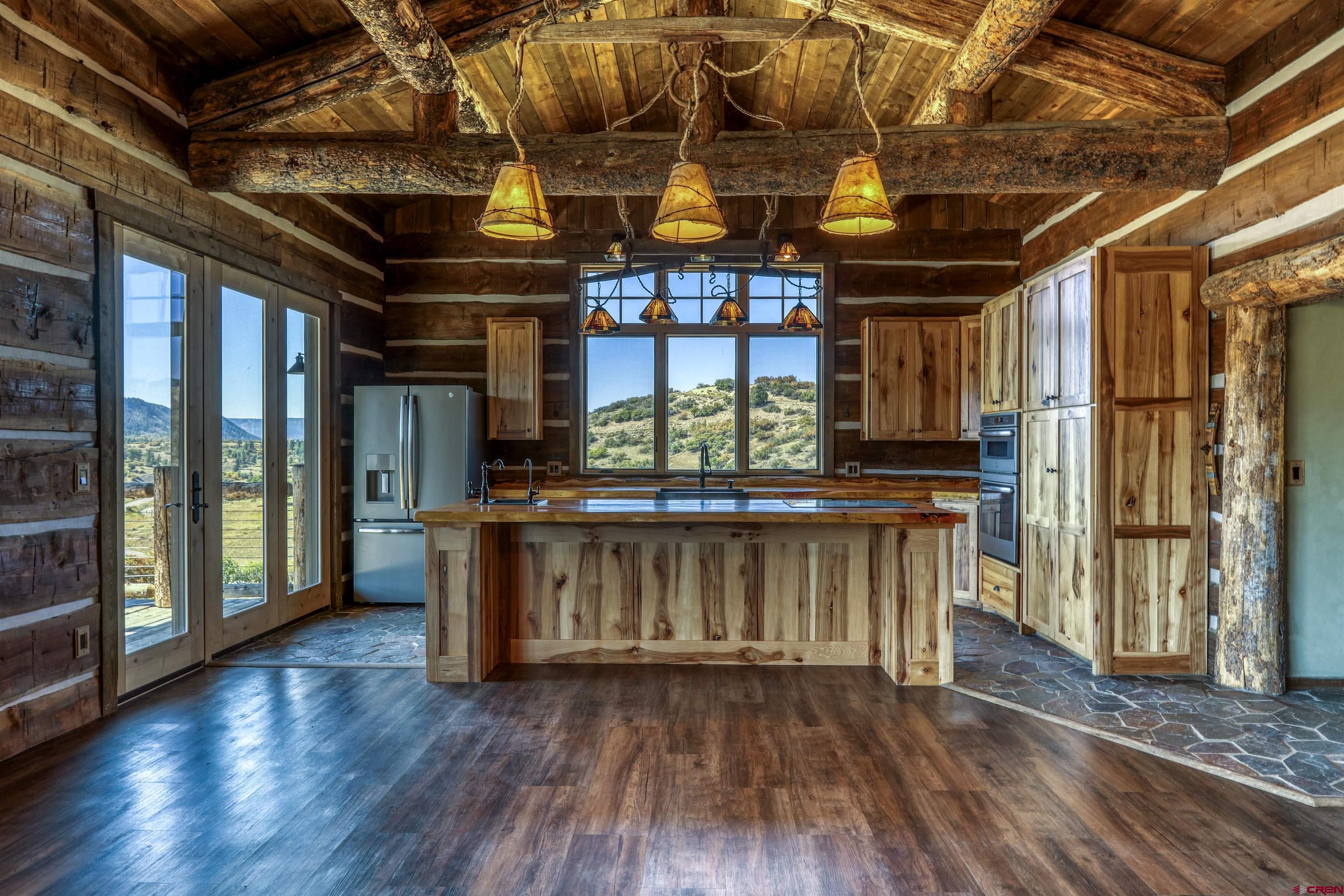 521 Spring Creek Circle Chromo, CO 81128 - Photo 6 of 35 a view of an empty room with wooden floor